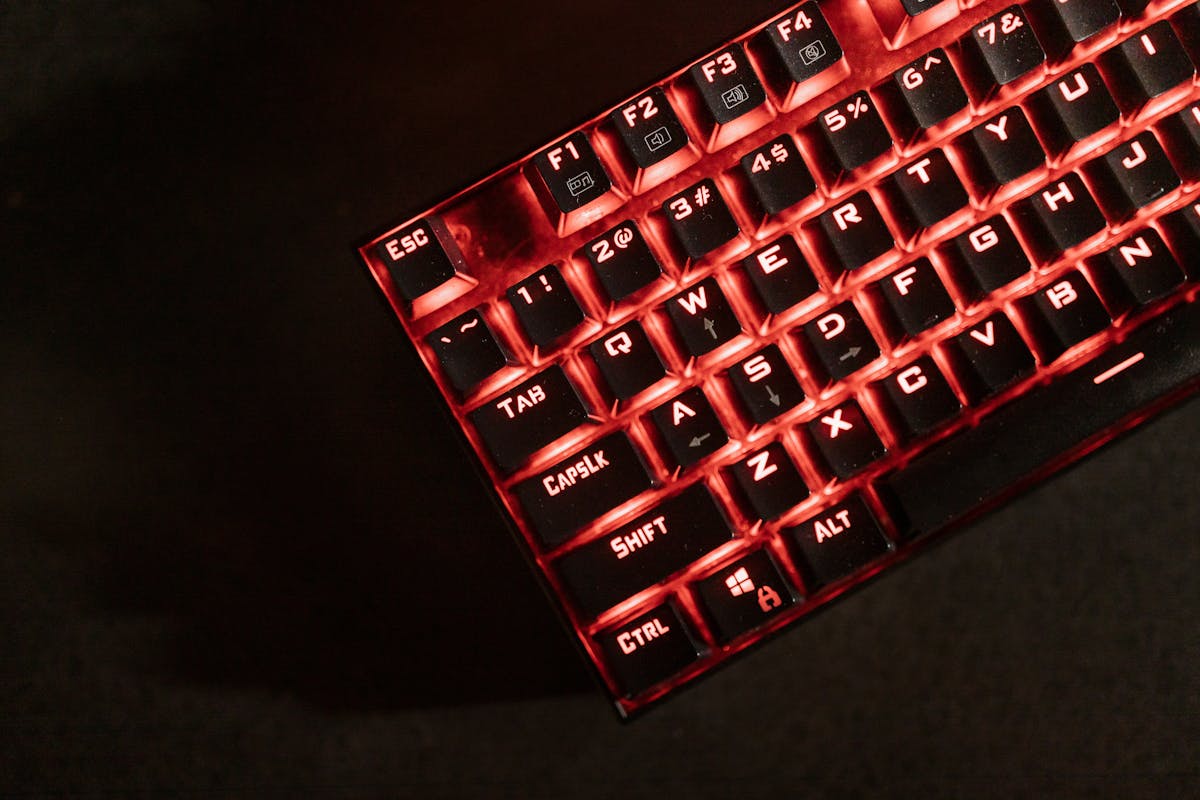 Red backlit mechanical gaming keyboard in the dark